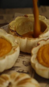 Spoon scooping the soft flesh from a roasted mini pumpkin