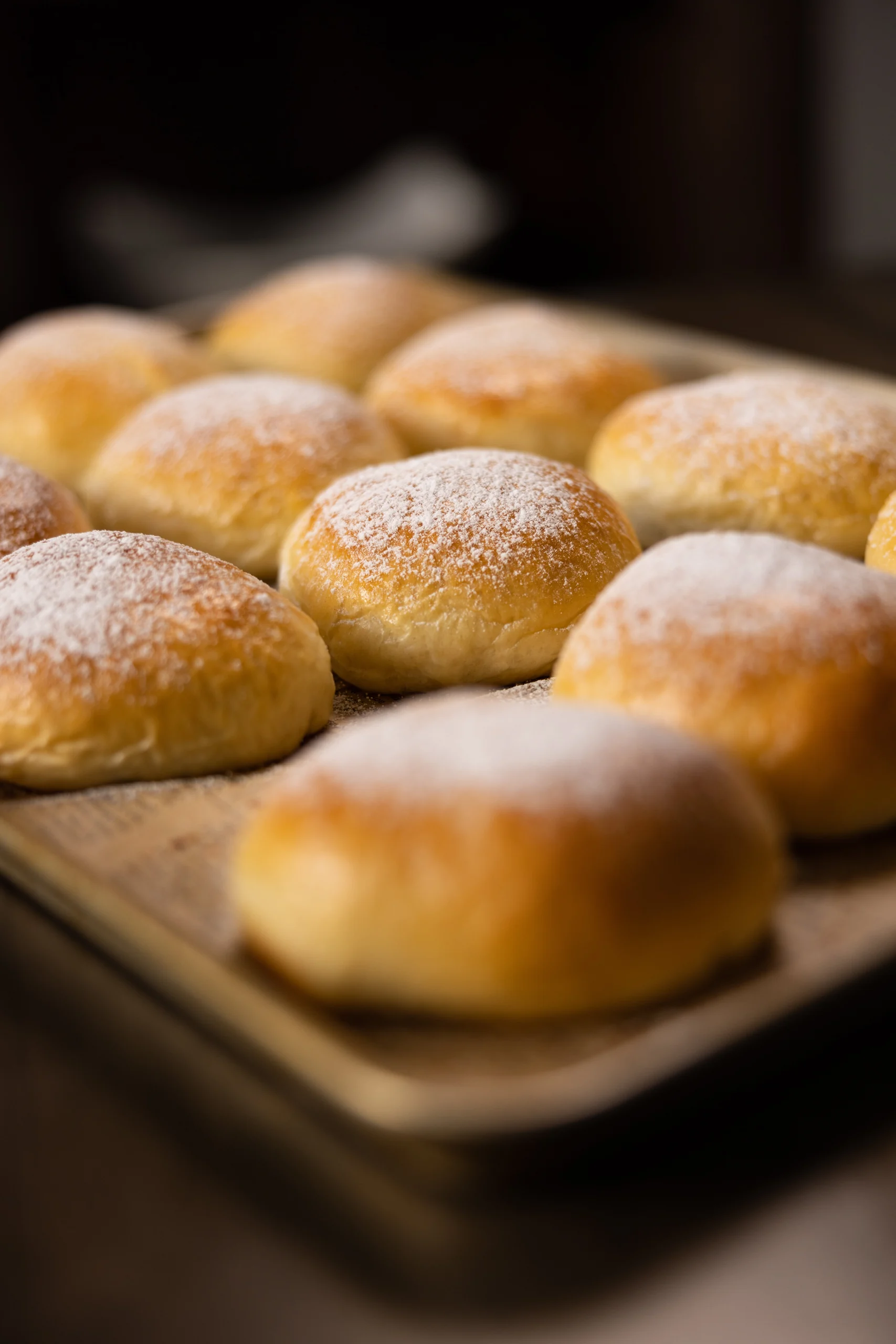 Round pastries dusted with powdered sugar