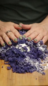 Flour being mixed into the purple potato gnocchi dough